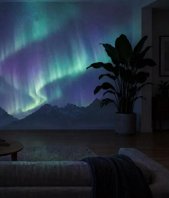 A living room wall lit with a projected northern-lights scene